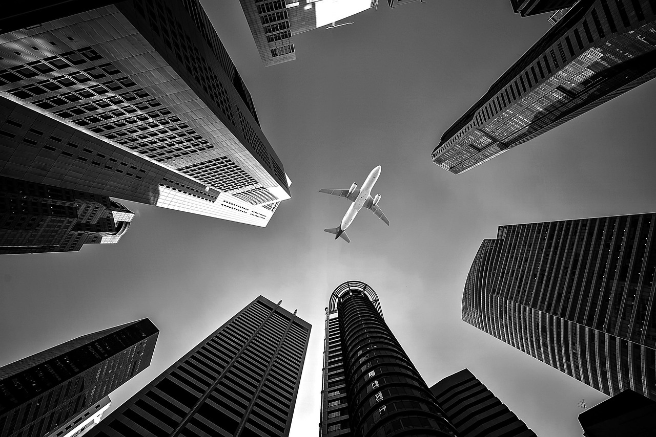 Photo by sasint airplane, buildings, perspective, skyscrapers, nature, flight, sky, high-rise, high-rise buildings, urban, city, airline, architecture, jet, transport, transportation, monochrome, black and white